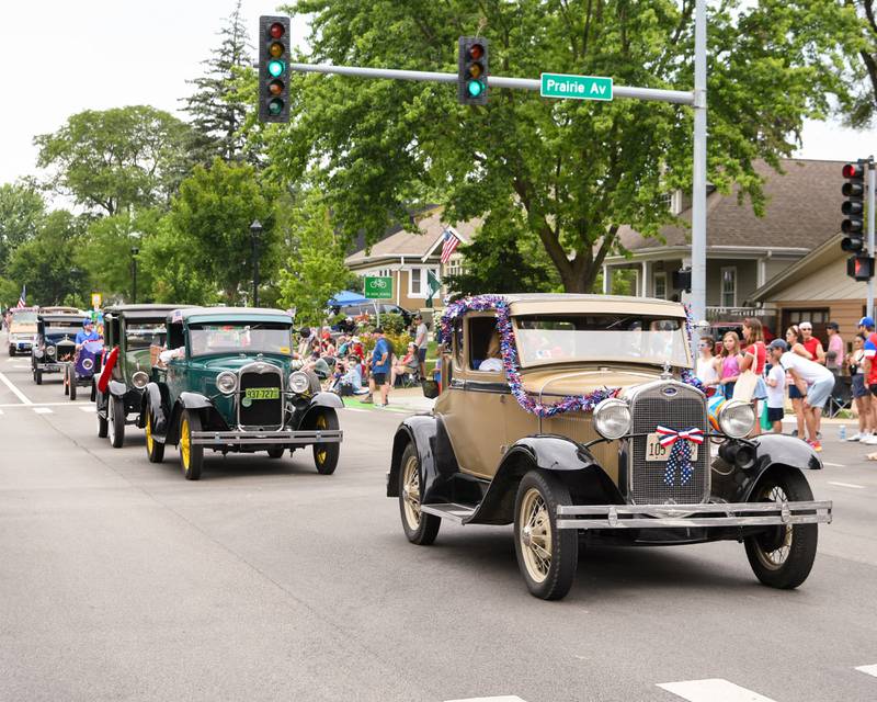 Antique cars drive down Main Street on Friday July 4, 2025, during the Independence Day Parade in downtown Downers Grove.