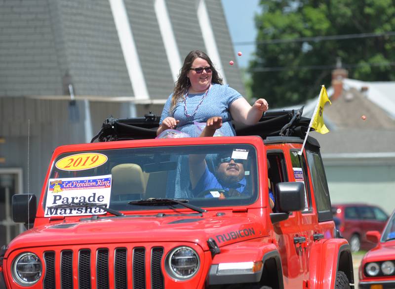 Melissa Rojas, parade marshal, tosses candy to the crowd during the Let Freedom Ring parade on July 4.