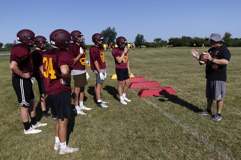 Richmond-Burton coach Mike Noll talks to his players during summer football practice Thursday, July 14, 2022, at Richmond-Burton High School in Richmond.