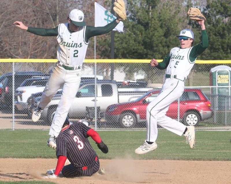 Hall's Jack Jablonski slides in safely to second base as St. Bede's Gus Burr and Sturart McGunnigal catch the late throw on Monday, March 31, 2025 at Schweickert Stadium in Peru.