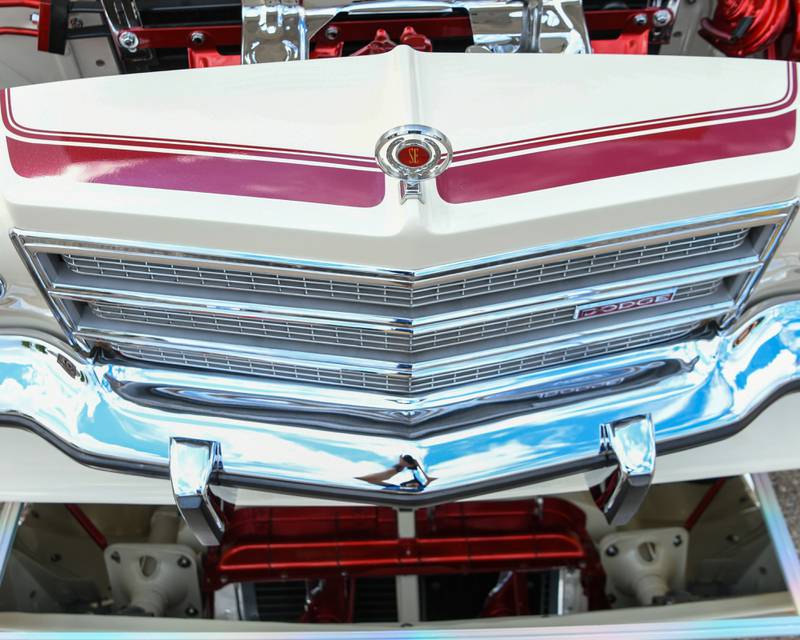 A mirror is placed on the ground to show off the underside of a 1977 Dodge Charger SE on Sunday July 27, 2025, during the Turning back time car show in downtown Sycamore.