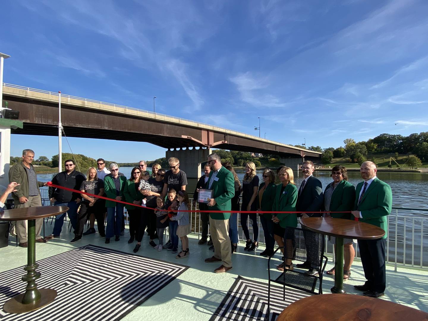 The Ottawa Area Chamber of Commerce and Industry ambassadors cut the ribbon on the St. Genevieve Riverboat with Gentry Nordstrom, Nathan Weiss and their families.