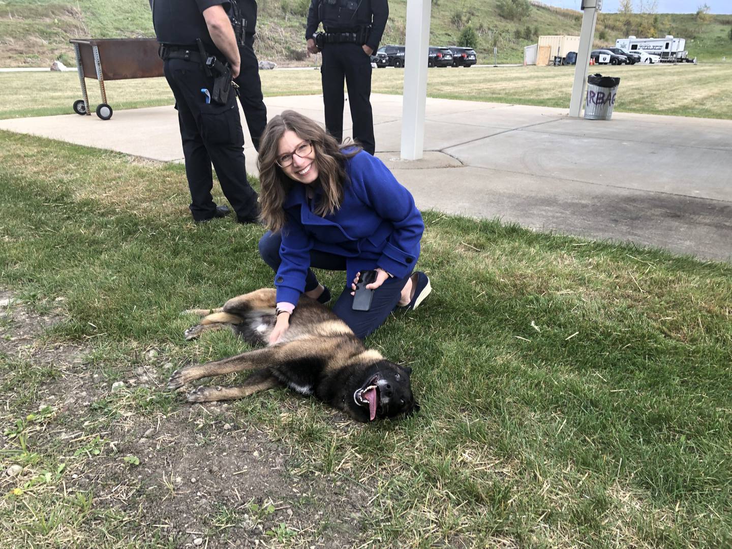 St. Charles Alderperson Jayme Muenz pets police K-9 Saint at the open house event for the St. Charles Police Department's new Public Safety Training Center on Oct. 14, 2024, at 3825 Karl Madsen Drive in St. Charles.