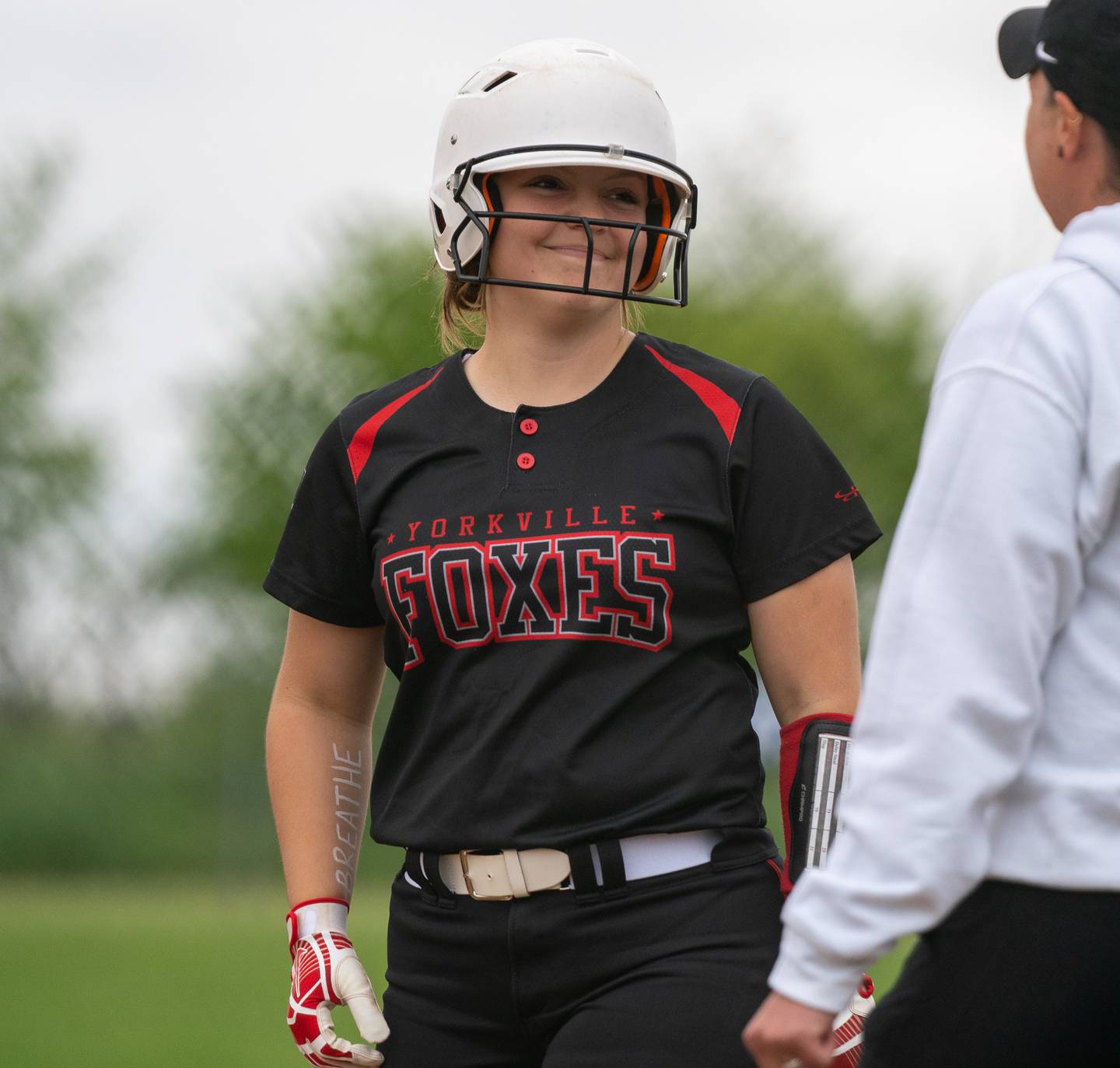 Yorkville's Lauren Koster (23) smiles after reaching first on a single against Plainfield North during the Class 4A Oswego East Regional softball final at Oswego East High School on Friday, May 27, 2022.