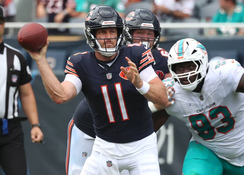 Chicago Bears quarterback Case Keenum delivers a pass just before taking a hard hit from Miami Dolphins defensive tackle Zeek Biggers, who was called for a peanalty on the play, Sunday, Aug. 10, 2025, during their game at Soldier Field in Chicago.