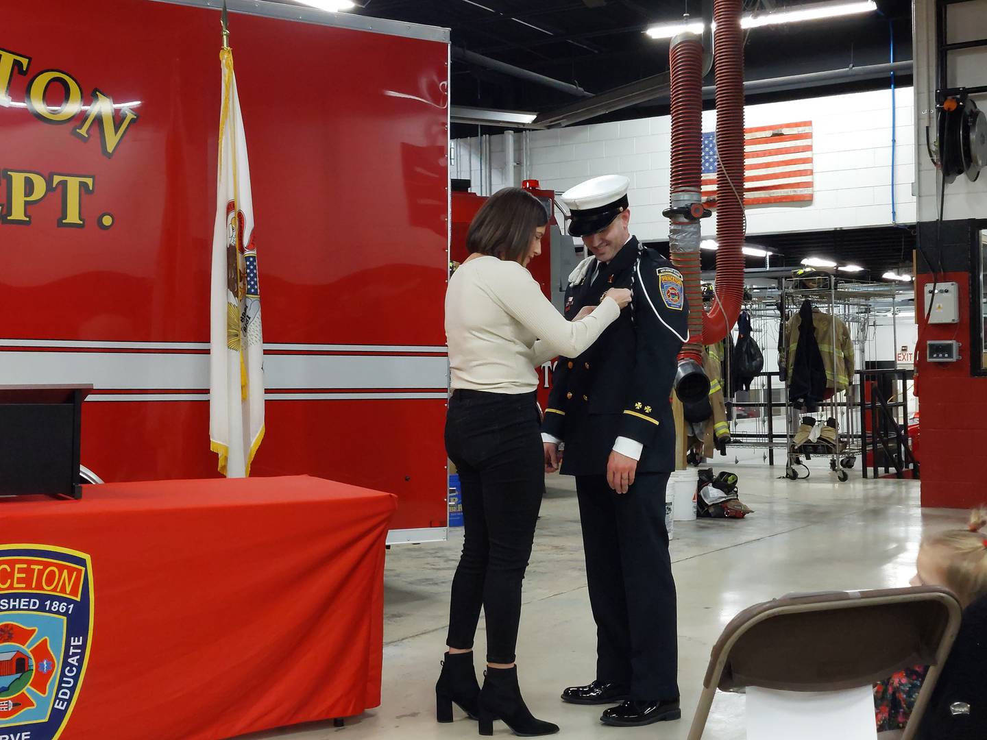 Haley VanAutreve puts a pin on her husband Eli VanAutreve, who was sworn in Monday, Feb. 5, 2024, as lieutenant of the Princeton Fire Department.