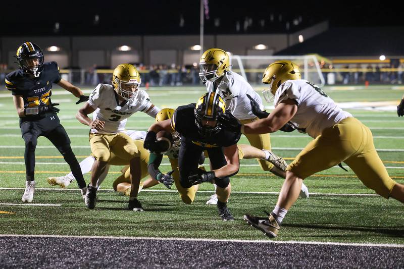 Herscher's Jaxon Sukley dives toward the end zone past Bishop McNamara defenders for a touchdown during the Fightin' Irish's 45-28 victory over the Tigers on Friday, Sept. 5, 2025.
