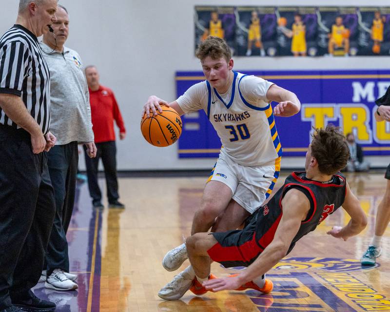Johnsburg's Jayce Schmitt (30) dribbles ball into a falling Preston Morel (3) of Aurora Christian during the Class 2A Boys Sectional Basketball tournament game on Wednesday, March 4, 2026 at Mendota High School. Officials called a blocking foul against Morel.