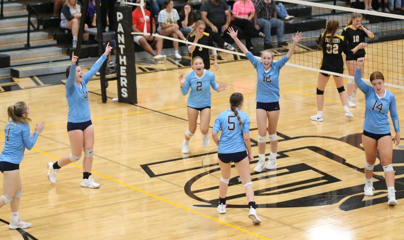 Members of the Marquette volleyball team celebrate after defeating Putnam County in two sets on Thursday, Sept 7, 2023 at Putnam County High School.