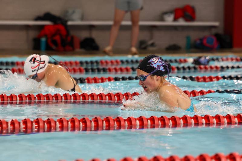 Kankakee's Arden Chandler, right, looks to catch Bradley-Bourbonnais' Bria McCrary in the 100-yard breaststroke during Bradley-Bourbonnais' victory over Kankakee and Bishop McNamara in the All-City swim meet on Tuesday, Sept. 9, 2025.