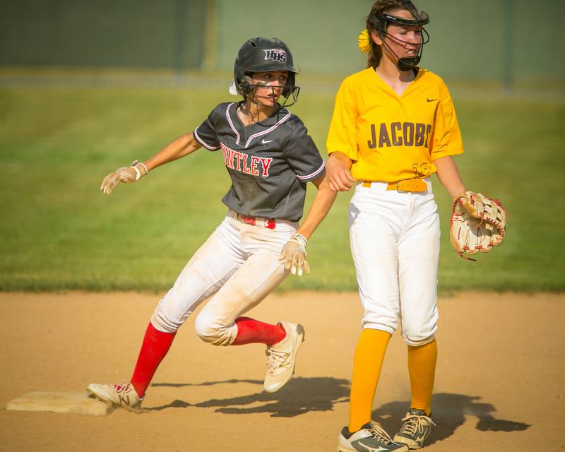 Huntley's Katie Mitchell (12) looks to home plate after stealing second base in the fifth inning of the game at Harry D. Jacobs High School, Algonquin, Ill., on Tuesday, June 8, 2021. The Red Raiders won, 11-0 through 6 innings, and will host Harlem Thursday, June 10, in the Sectional Championship.