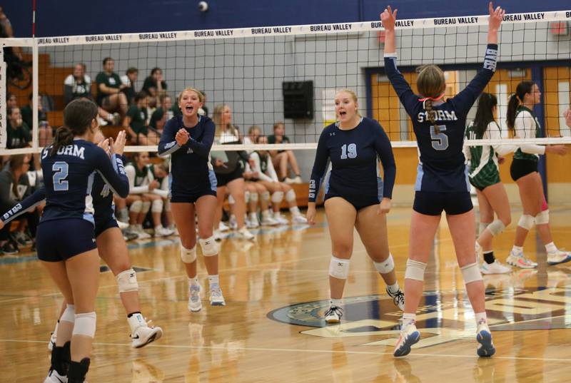 Members of the Bureau Valley volleyball team celebrate after winning the first set over St. Bede on Tuesday, Sept. 5, 2023 at Bureau Valley High School.