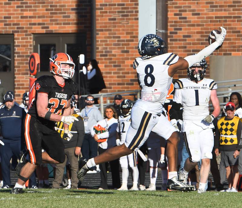 Elmhurst IC Catholic's Tamarion Garner (8) reaches for a pass as Byron's Caden Considine (37) watches during 3A quarterfinals at Byron High School on Saturday, Nov. 15, 2025. The pass was incomplete.