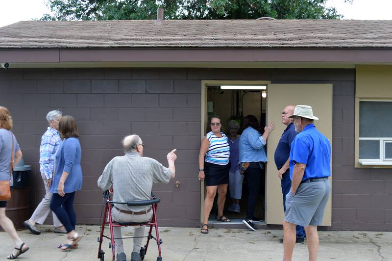 City officials and members of the Burkardt family and Polo Lions Club check out the interior of the new concession stand at Millard Deuth Westside Park on July 29, 2024.