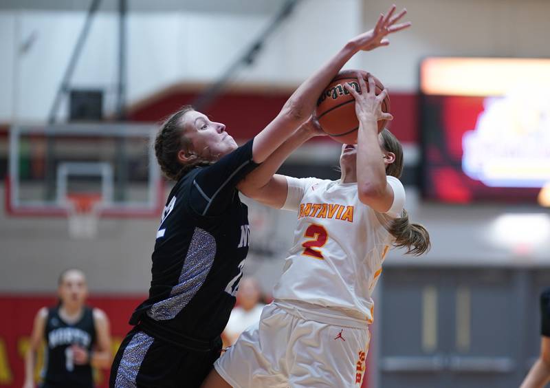 St. Charles North's Katrina Stack (22) blocks a shot by Batavia's Brooke Carlson (2) during a basketball game at Batavia High School on Tuesday, Dec 5, 2023.