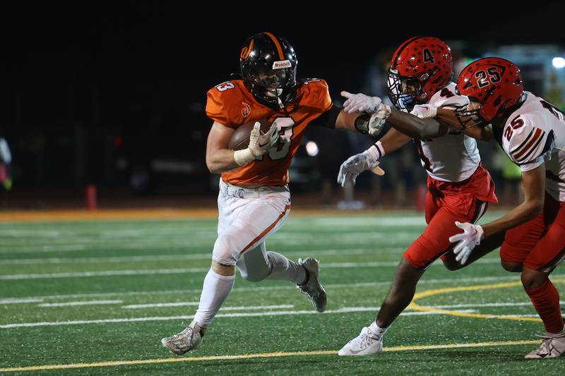 Lincoln-Way West’s Joey Campagna stiff arms a defense on a run against Bolingbrook on Friday, Sept. 22 in New Lenox.