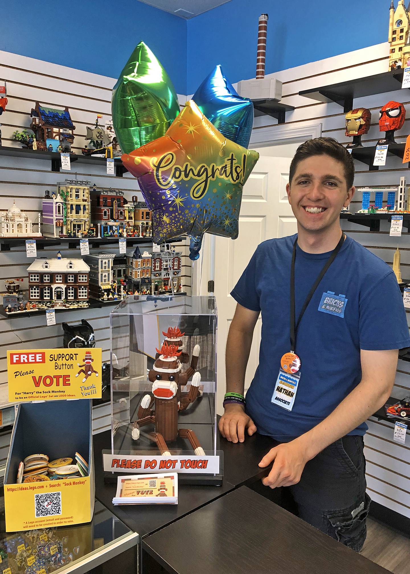 Nathan Lilliebridge with a duplicate copy of Harry the Sock Monkey at Bricks and Minfigs in Algonquin after Harry reached 1,000 supporters on Lego Ideas.