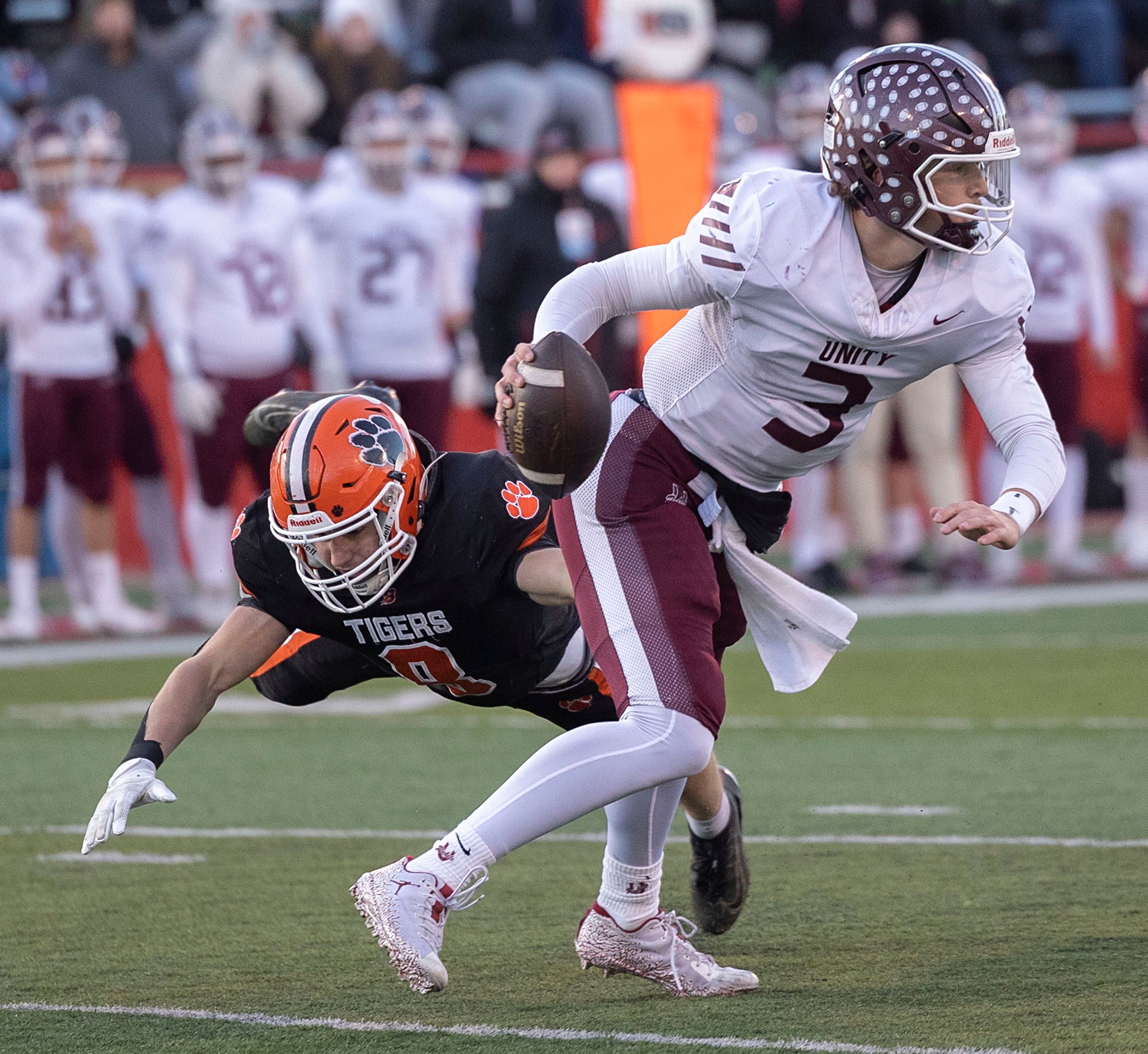 Tolono-Unity's Dane Eisenmenger scrambles away from Byron's William Julian Friday, Nov. 28, 2025, in the Class 3A football finals at Hancock Stadium at ISU.