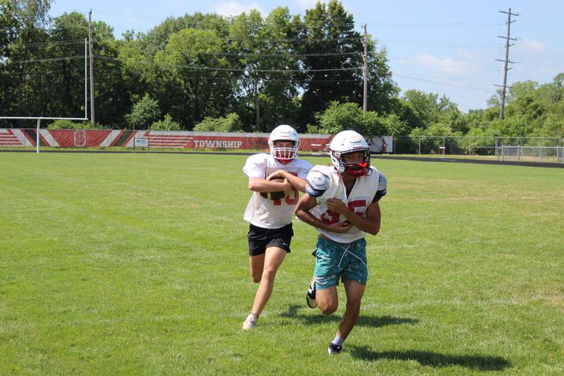 Streator's Jesus Martinez (95) leads the way for ballcarrier Sam LeRette (16) during practice at Doug Dieken Stadium in Streator.
