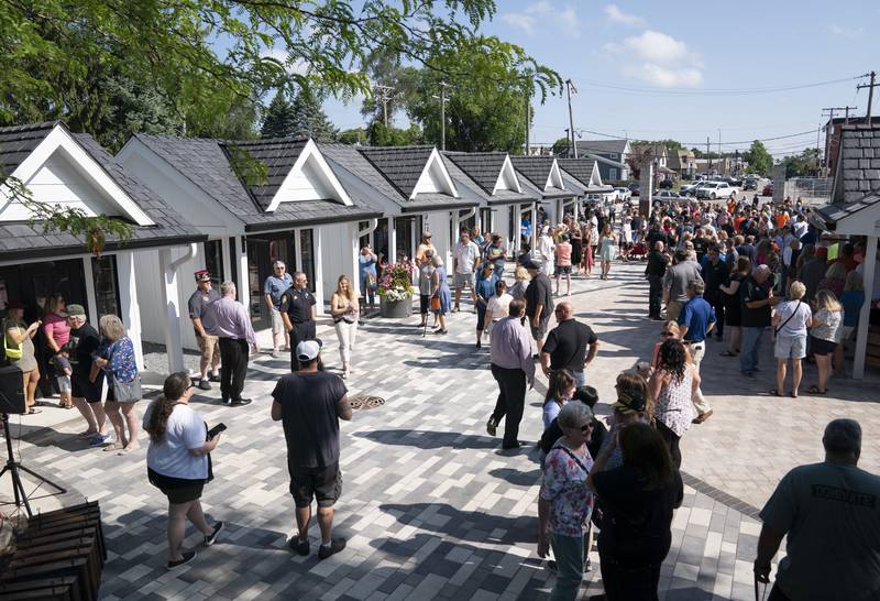 Shoppers explore the new collection of tiny shops at the grand opening and ribbon cutting of the new McHenry Riverwalk Shoppes in downtown McHenry on Friday, July 21, 2023. Ryan Rayburn for Shaw Local