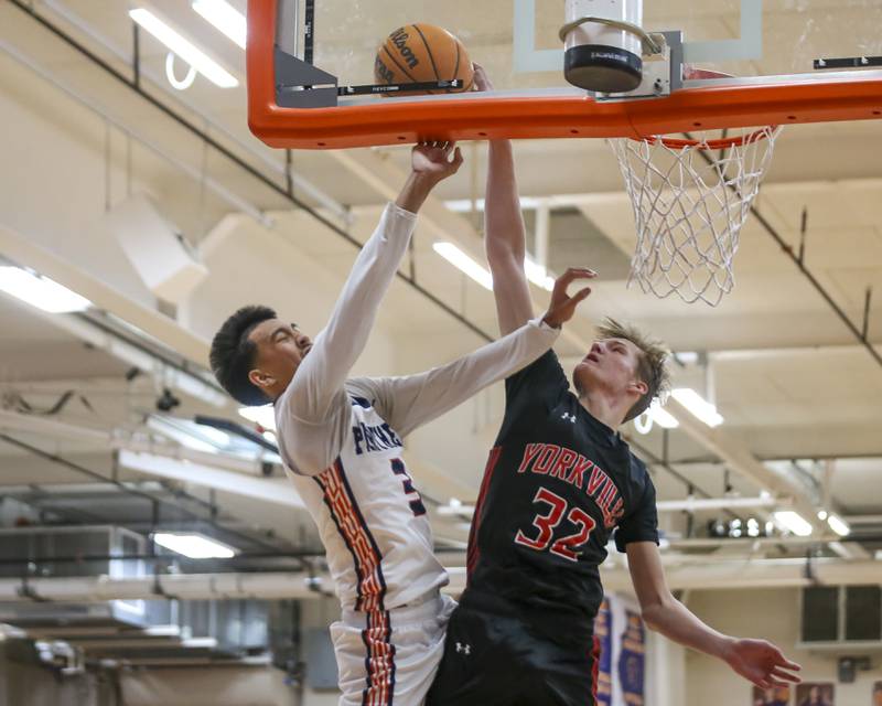 Oswego's Ethan Vahl (3) is met at the rim by Yorkville's Joey Jakstys (32) during their basketball game between Yorkville at Oswego, Feb 7, 2026 in Oswego.