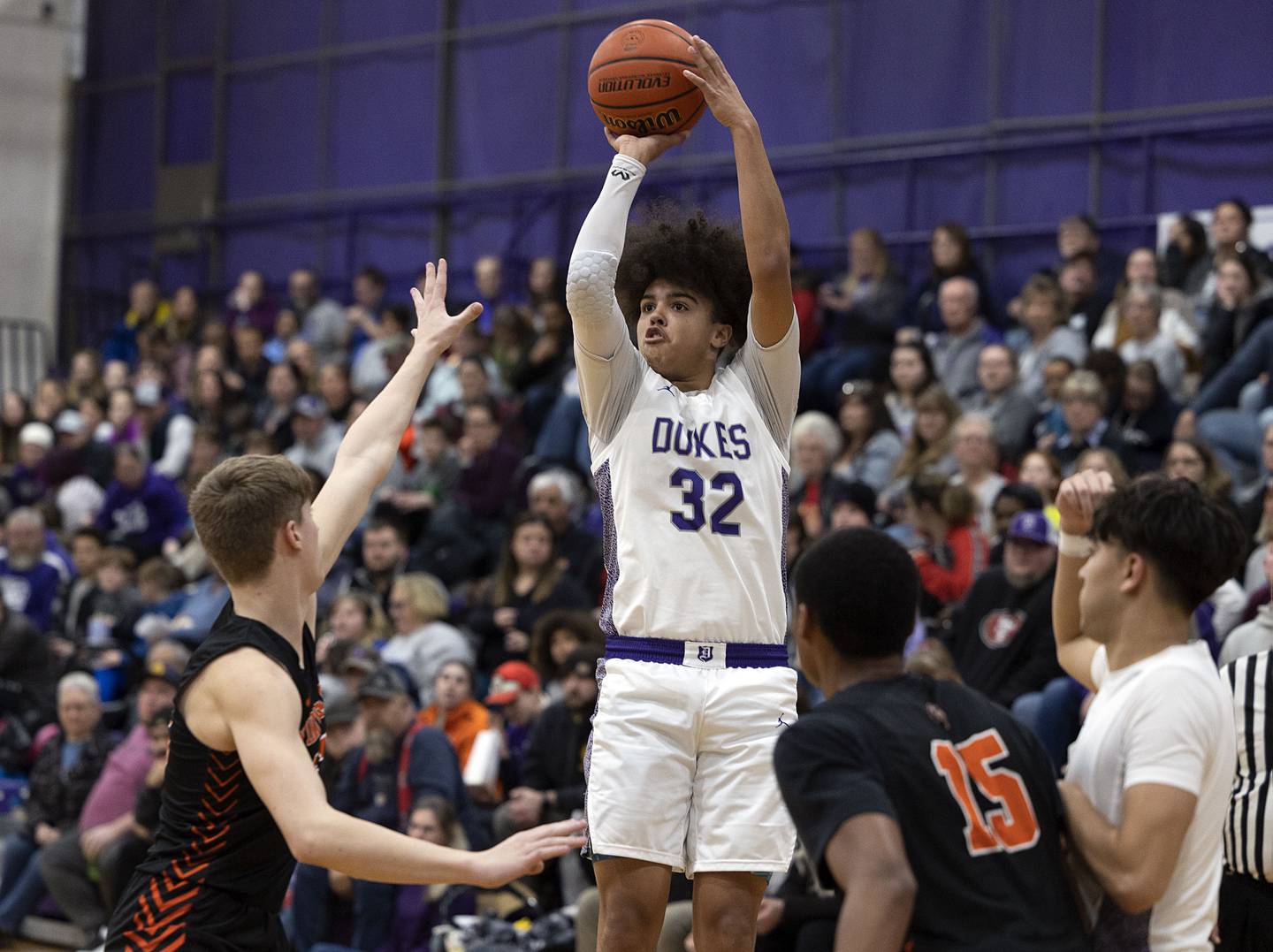 Dixon’s Darius Harrington shoots over a Winnebago defender Thursday, Jan. 26, 2023.