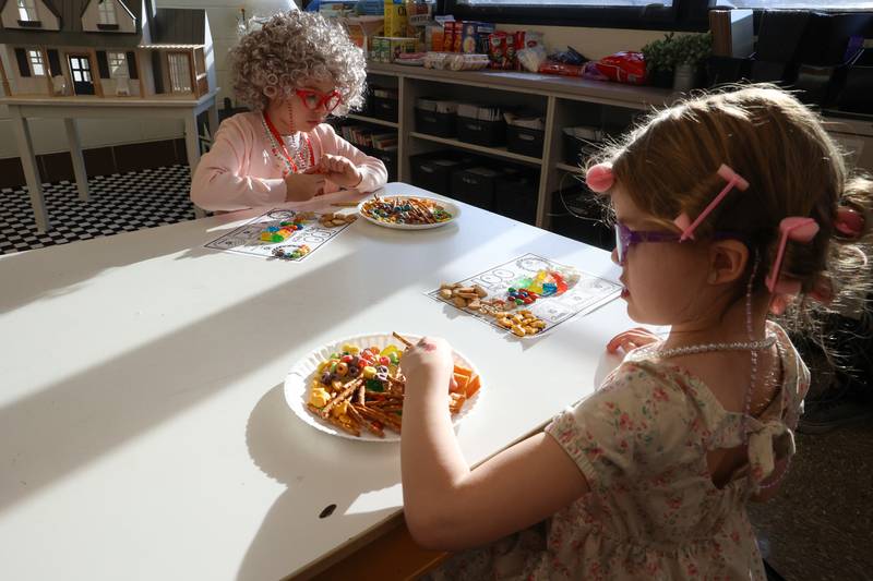 Shabbona Elementary School kindergarteners Posie Diaz, left, and McKenna Bass count up their snacks for a 100th day of school activity on Monday, Feb. 9, 2026.