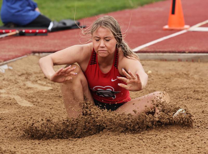 Lincoln Way's Kaitlyn Hutchinson sticks a long jump landing in the rain in the long jump during the girls varsity track and field 3A Lockport sectional on Friday, May 12, 2023.