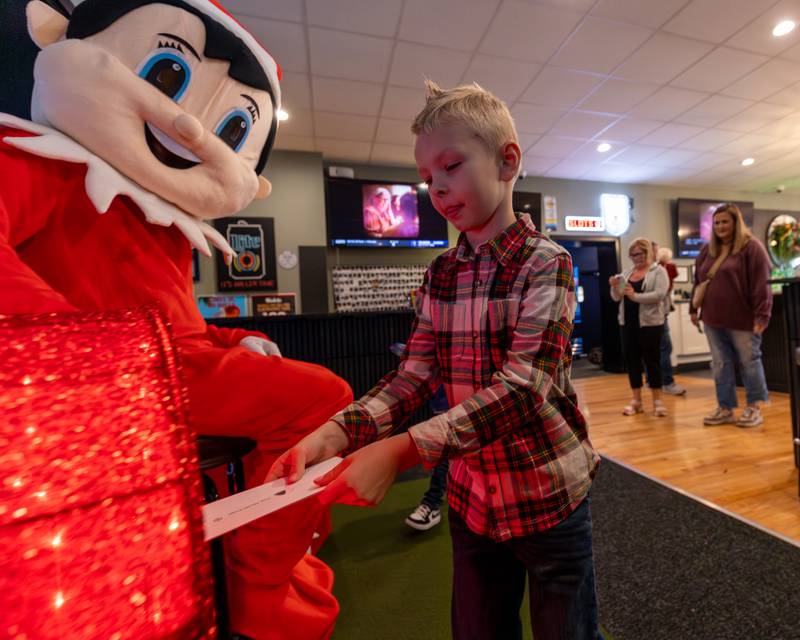 Brooks Ebener puts letter to Santa into box at the annual Christmas in the Valley on Saturday, November 15, 2025 at the Tee Box in Spring Valley.