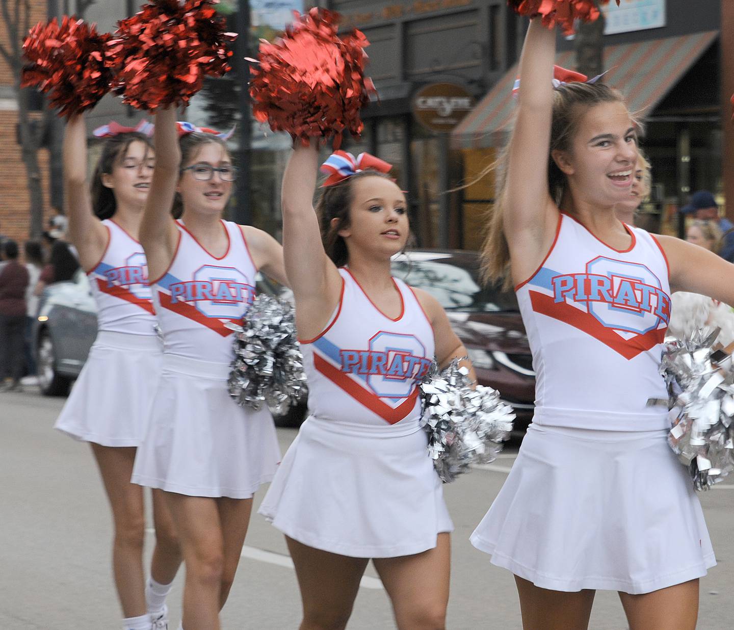 Cheerleaders for Ottawa High School cheer as they march Wednesday, Sept. 21, 2022, along LaSalle Street in Ottawa during the school’s homecoming parade.