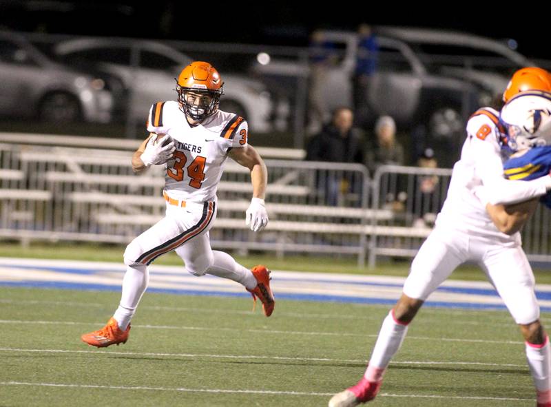 Wheaton Warrenville South’s Matthew Crider (34) runs the ball during a game at Wheaton North on Friday, Oct. 7, 2022.