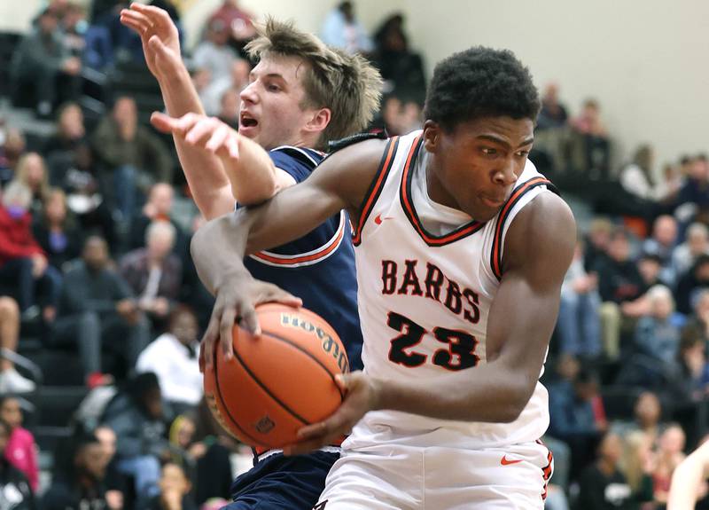 DeKalb’s Davon Grant grabs a rebound away from Naperville North's Jack Kallstrand during their game Friday, Dec. 8, 2023, at DeKalb High School.