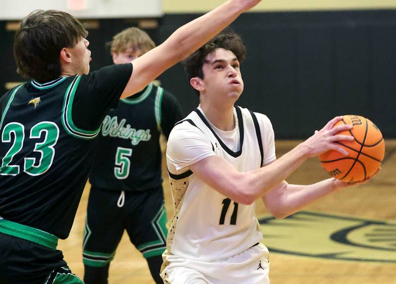 Sycamore's Jake Shipley goes to the basket against North Boone's Michael Persson during their game Tuesday, Dec. 3, 2024, at Sycamore High School.