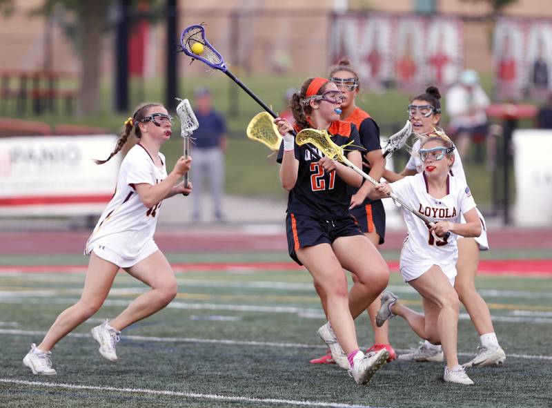 Crystal Lake Central Coop's Anna Star (27) attempts to break through the Loyola Academy defense during the lacrosse state semi-final match between Crystal Lake Central and Loyola Academy on Thursday, June 5, 2025 in Hinsdale.