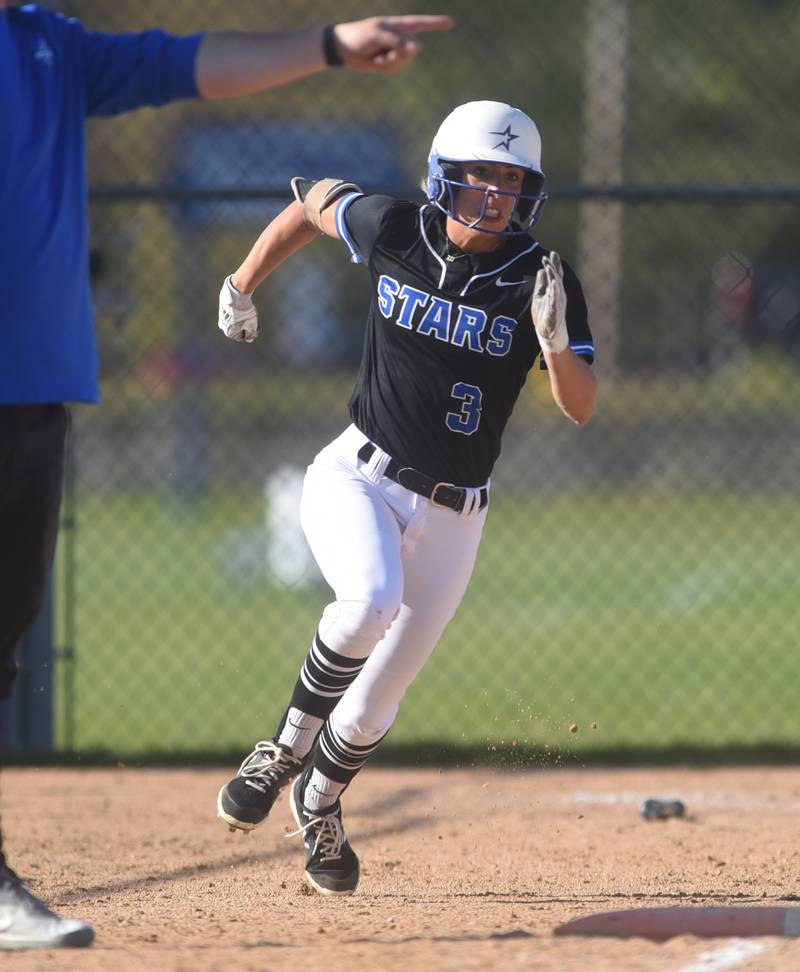 St. Charles North's Leigh VandeHei rounds first base after a hit during Wednesday’s softball game against Wheaton North in Wheaton.
