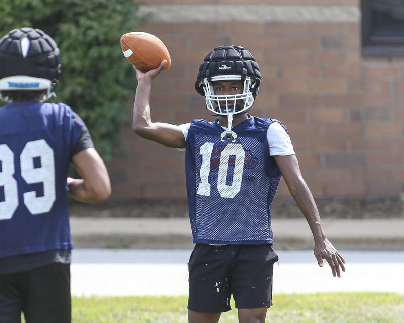 Jordan Walker tosses the ball to Dontrell Young at Oswego High School Football Practice, Monday, Aug 11, 2025  in Oswego.