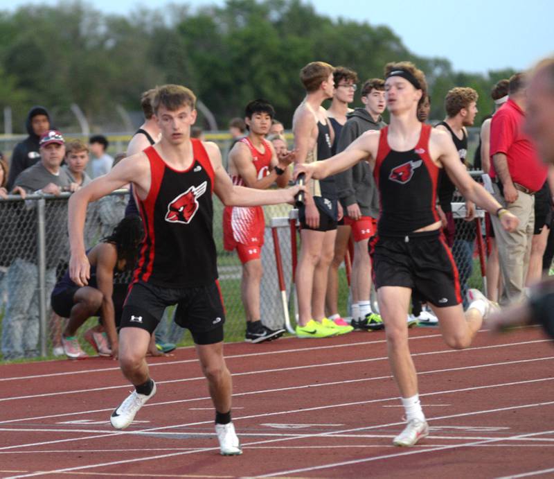 Forreston's Hayden Vinnedge (left) gets the baton from Brody Schwartz in the 4x400 relay at the 1A Oregon Sectional at Landers-Loomis Field on Friday, May 23, 2025. The Cardinals took second in the race and advanced to the state meet at Eastern Illinois University on Thursday, May 29.