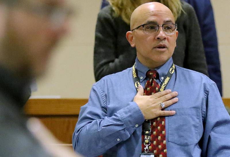 This Northwest Herald file photo shows McHenry County Board member Carlos Acosta standing for the Pledge of Allegiance at a Dec. 6, 2018, board meeting at the McHenry County Administration Building in Woodstock.