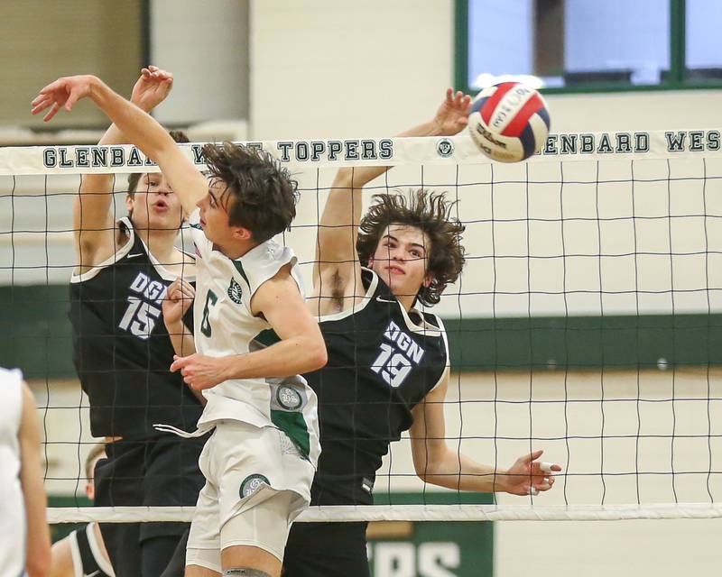 Downers Grove North's Zak Baker (19) gets a kill during volleyball match between Downers Grove North at Glenbard West.  April 2, 2024.