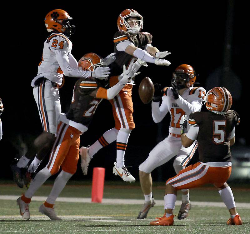 A host of Hersey players knock down the last Wheaton Warrenville South pass of the game during the IHSA Class 7A playoffs Saturday October 28, 2023 in Arlington Heights.