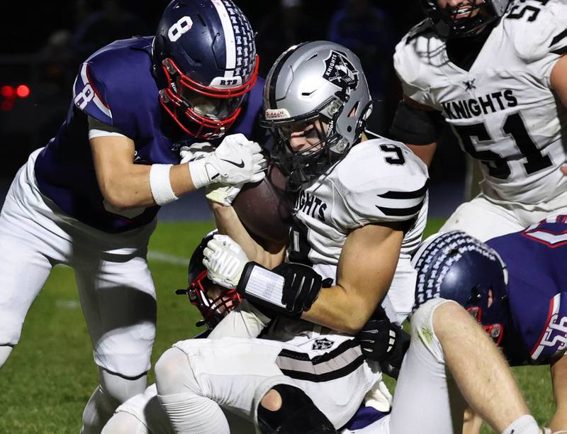 Kaneland's Carter Grabowski is brought down by a pair of Belvidere North defenders Friday, Nov. 7, 2025, during their Class 5A second round playoff game at Belvidere North High School.