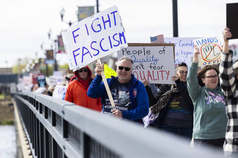 Organized by Indivisible SRFD, a group marches across the First Avenue bridge into Sterling Saturday, May 3, 2025, to protest the Trump administration and show their support for workers’ rights. The crowd started at RB&W Park in Rock Falls and marched to Grandon Civic Center in Sterling.