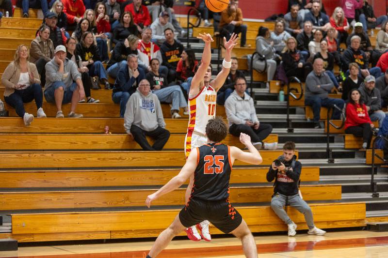 Batavia's Joe Reid shoots a three pointer over St. Charles East's Gavin Belli on Friday, Jan.9,2026 in Batavia.