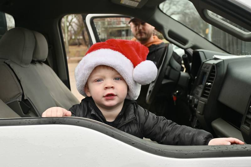 Ky Picha, 2, of La Salle awaits Officer Santa's arrival on Saturday, Dec. 16.