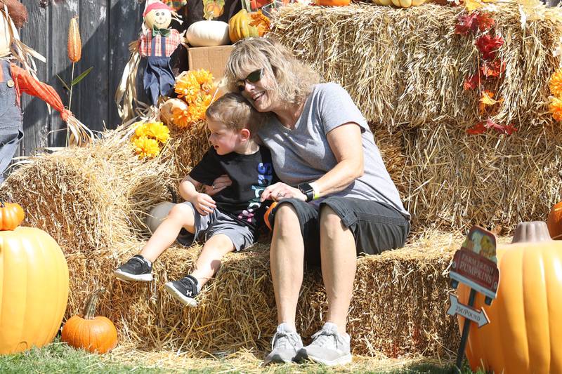 Sheila O’halloran enjoys a moment with her grandson Chase Garstka, 2-years old, while sitting on a hay stack at the Autumn Family Fun Fest on Saturday, Sept. 23, 2023 in Plainfield.