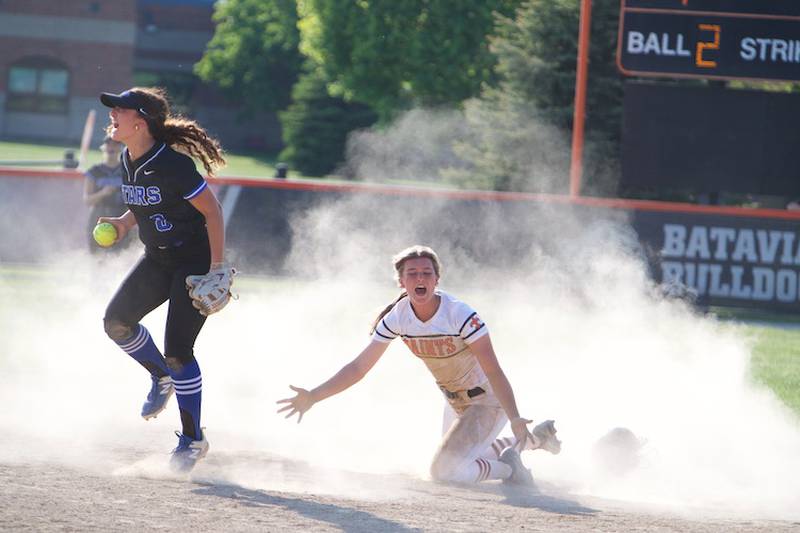 St. Charles Norths Ginger Ritter jumps in celebration after tagging out St. Charles East's Addison Wolf reacts to the call at second base on Wednesday May 14,2025 in St. Charles.