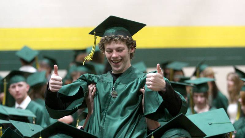 Steven Wilson gets a celebratory lift from classmates as they line up  for graduation at Crystal Lake South High School in Crystal lake on Saturday, May 17, 2025.