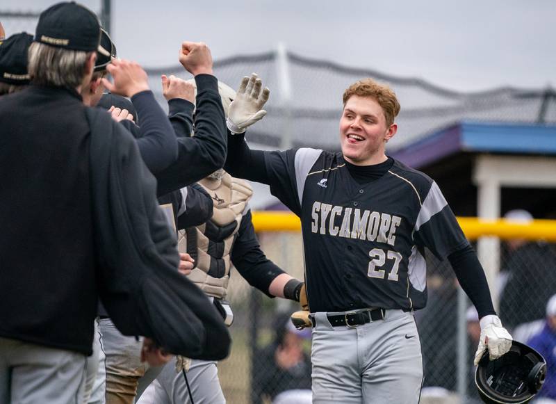Sycamore's Jimmy Amptmann (27) high fives team mates after homering against Plano during a baseball game at Plano High School on Monday, April 4, 2022.