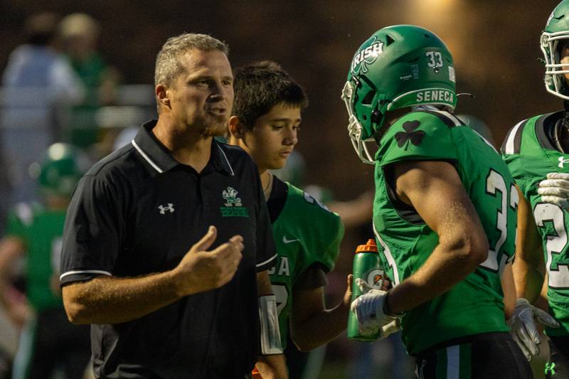 Seneca Head Coach, Terry Maxwell speaks to player Cameron Shriey (33) on sideline on Friday, Aug 29, 2025 at Seneca High School in Seneca.