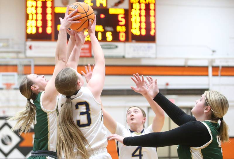 St. Bede's Ashlyn Ehm grabs a rebound over Marquette's Kelsey Cuchra while Marquette's Hunter Hopkins and St. Bede's Savannah Bray jolt toward the play during the Tri-County Conference championship game on Thursday, Jan. 23, 2025 at Roanoke-Benson High School.